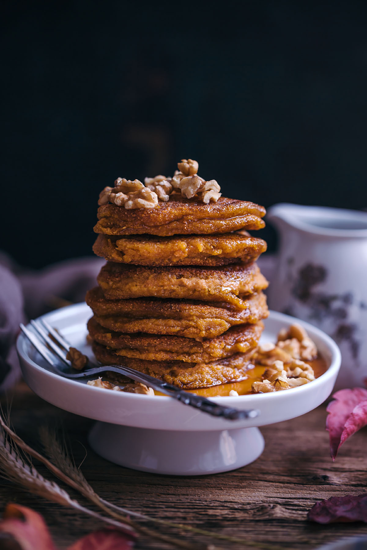 vegan pumpkin pancakes with maple syrup and walnuts