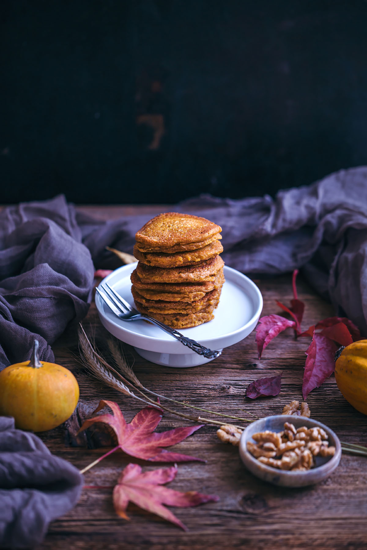 vegan pumpkin pancakes with maple syrup and walnuts