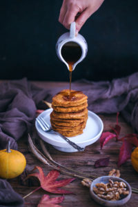 vegan pumpkin pancakes with maple syrup and walnuts