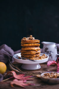 vegan pumpkin pancakes with maple syrup and walnuts