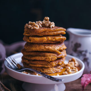 vegan pumpkin pancakes with maple syrup and walnuts