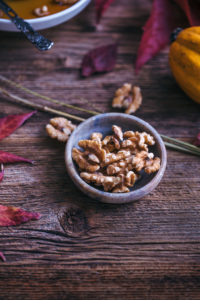 vegan pumpkin pancakes with maple syrup and walnuts