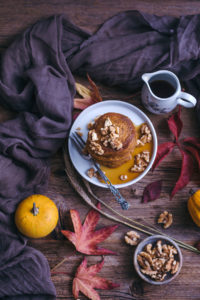 vegan pumpkin pancakes with maple syrup and walnuts